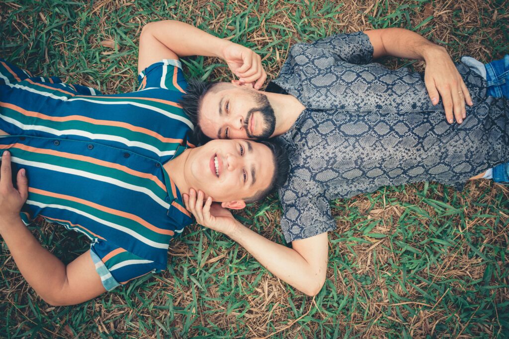 Two Men Lying on Green Grass