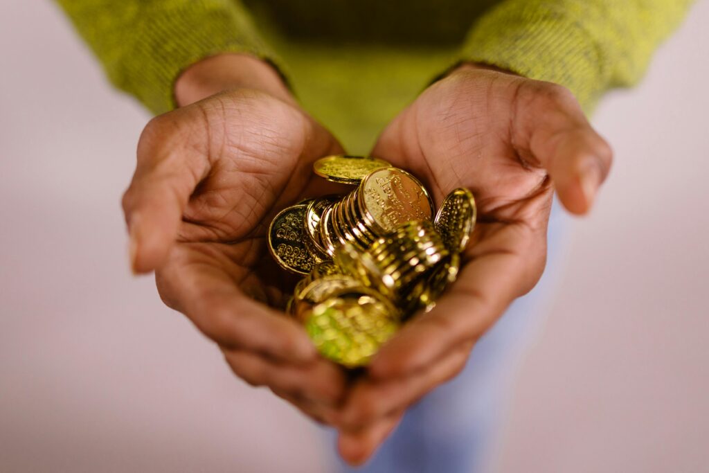 Gold Coins in Person's Hands