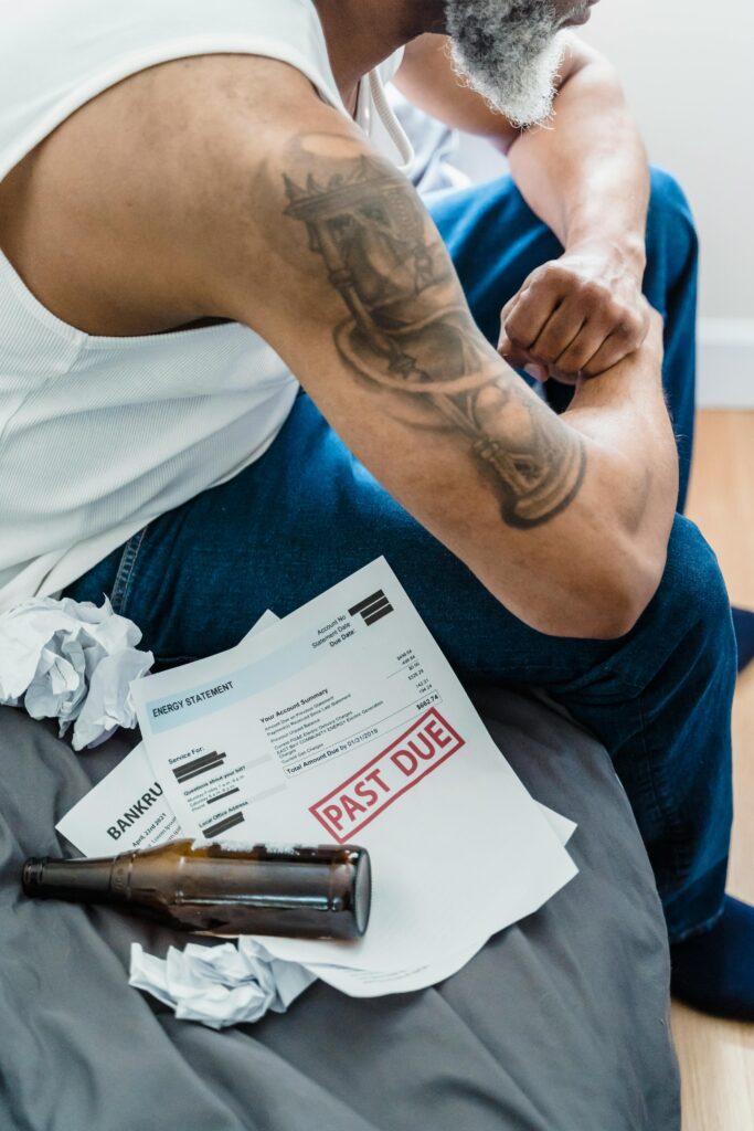 Man Sitting Next to a Past Due Billing Statement